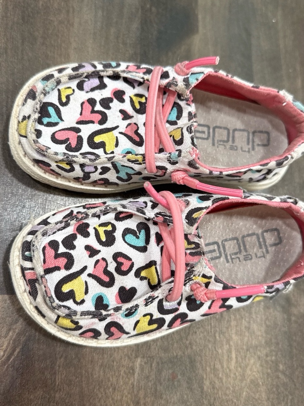 Hey Dude Kids Heart Print Slip-On Sneakers in Pink, Yellow, Teal, Black